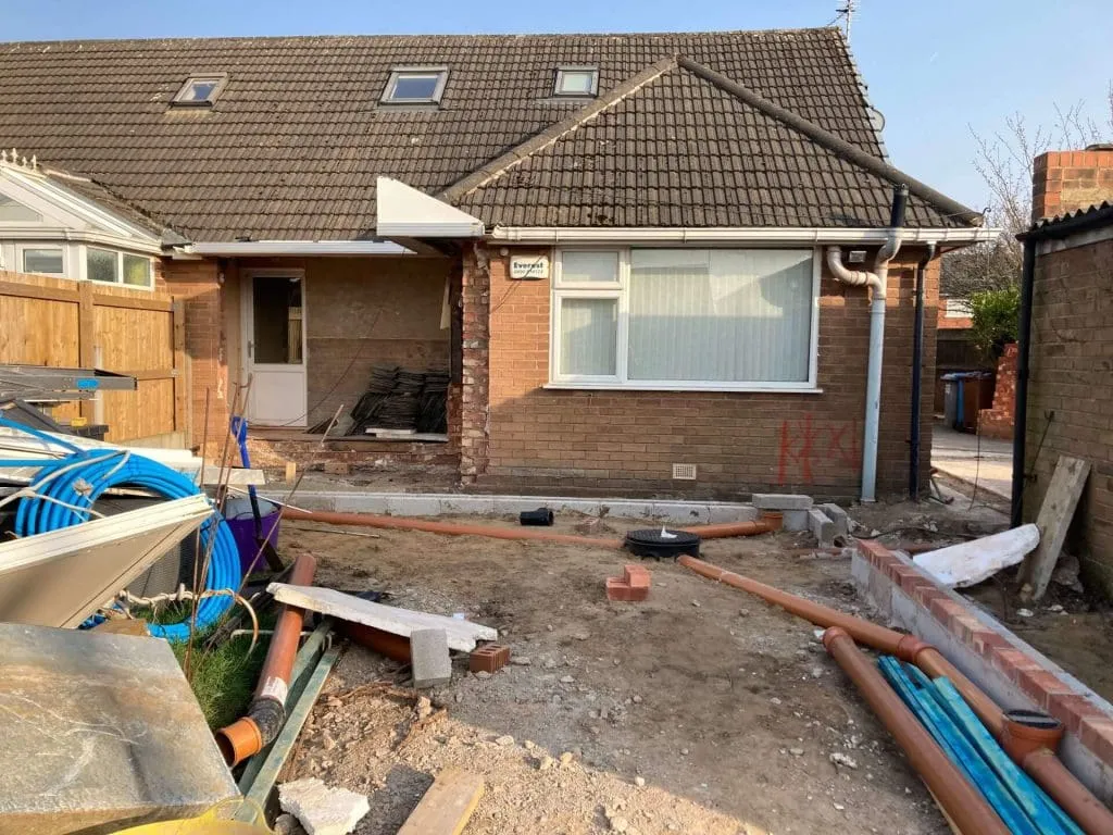 external view of house, work being undertaken in garden of home
