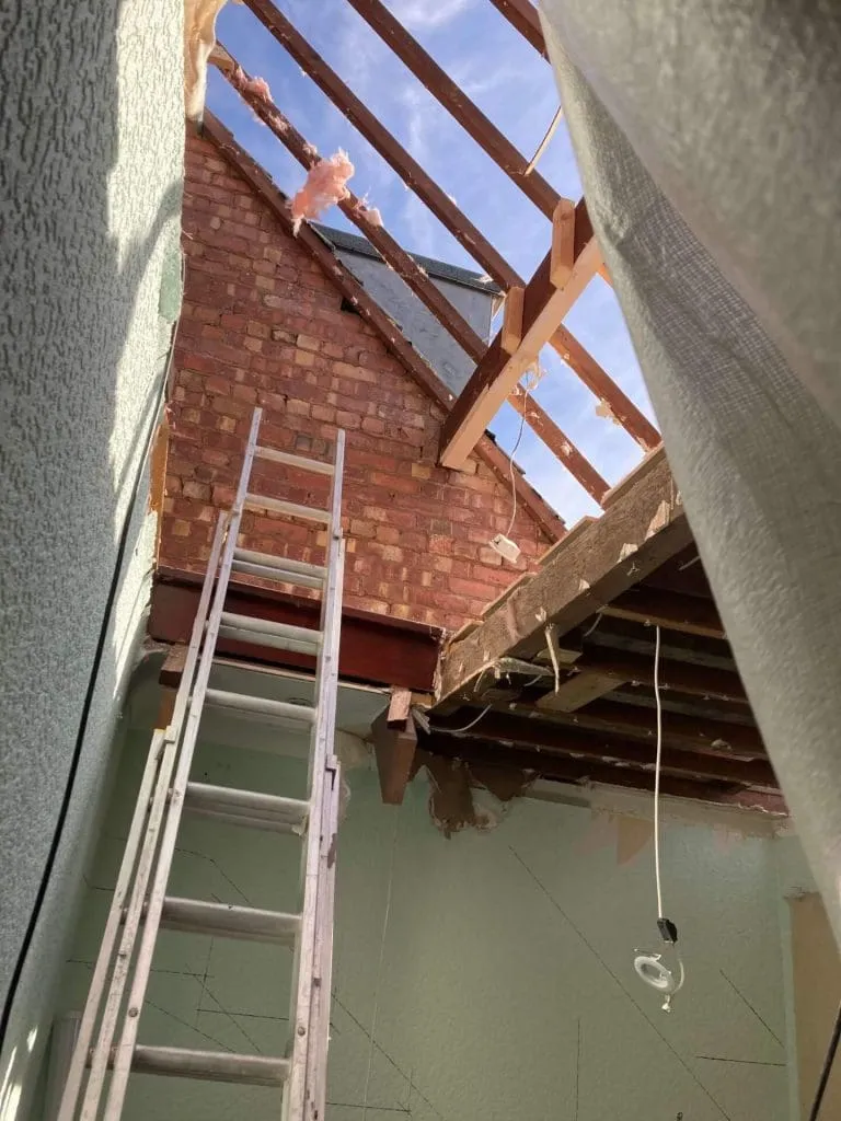 Hall work, place for stairs leading up to be installed with ladder propped again wall